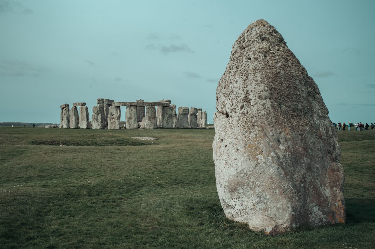 Standing stone at Stonehenge with the Heel Stone in the foreground, viewed from within the monument.