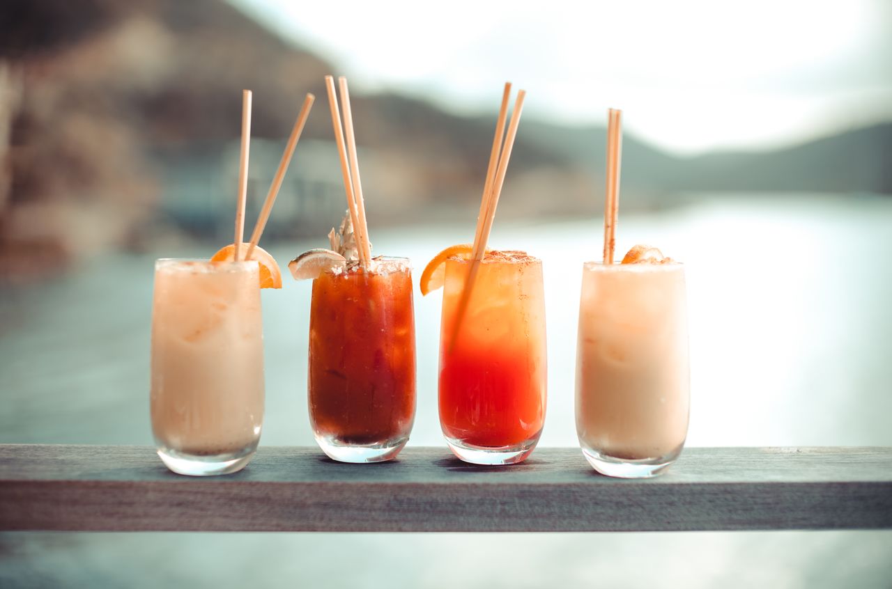 Painkillers and rum punches Four different rum cocktails lined up next to each others