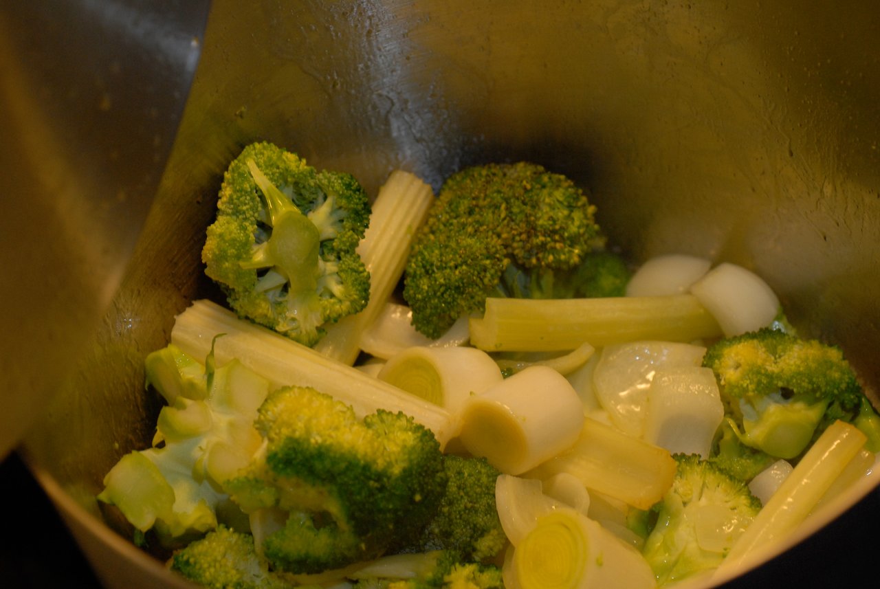 Chopped broccoli, leeks, and onions in a pot, prepared for cooking broccoli cream soup.