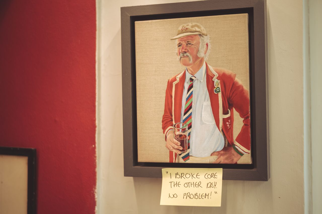 A painting of a man holding a beer. The frame has a sticky note with the text: "I broke core the other day. No problem!".