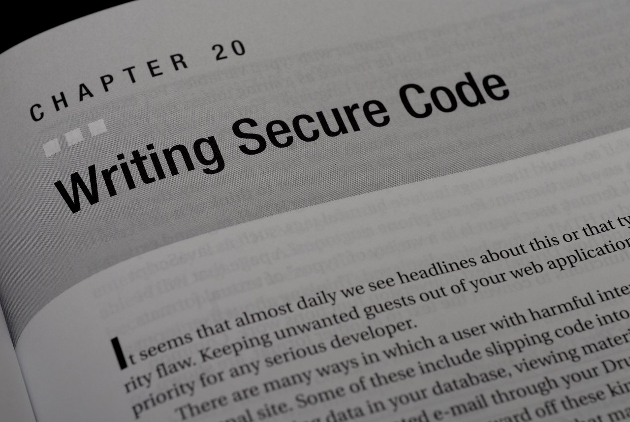 A book page showing Chapter 20 titled "Writing Secure Code", discussing security flaws in web applications.