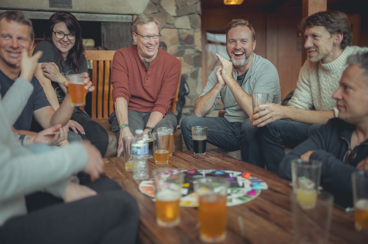 People seated around a table playing a board game.