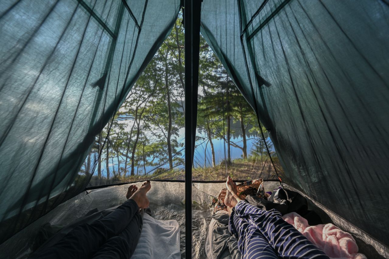 Good morning View from inside our tent: our legs are shown in the foreground and the ocean in the background.