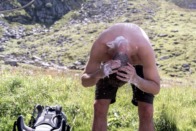 First shower after four days Dries washing his hair