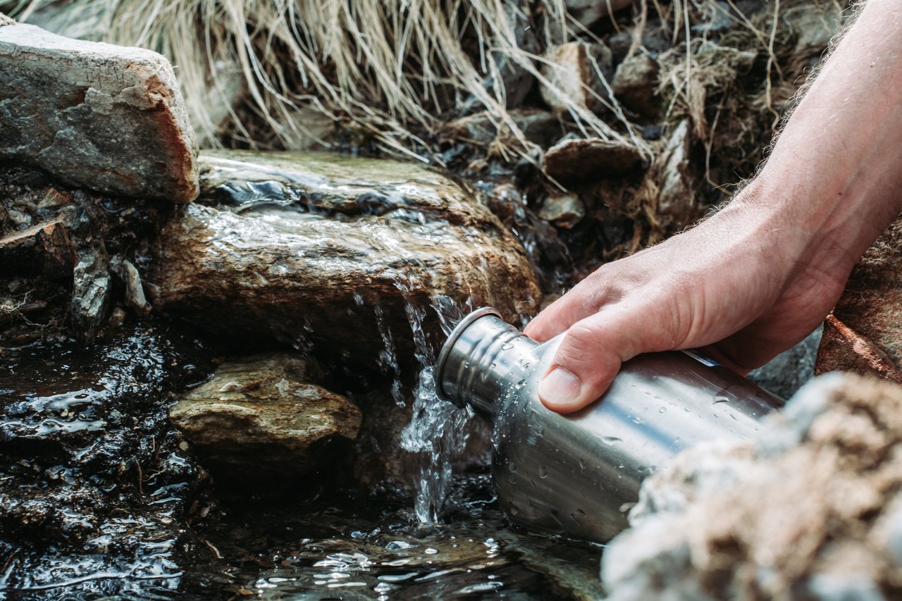 Refilling our water bottles on a creek