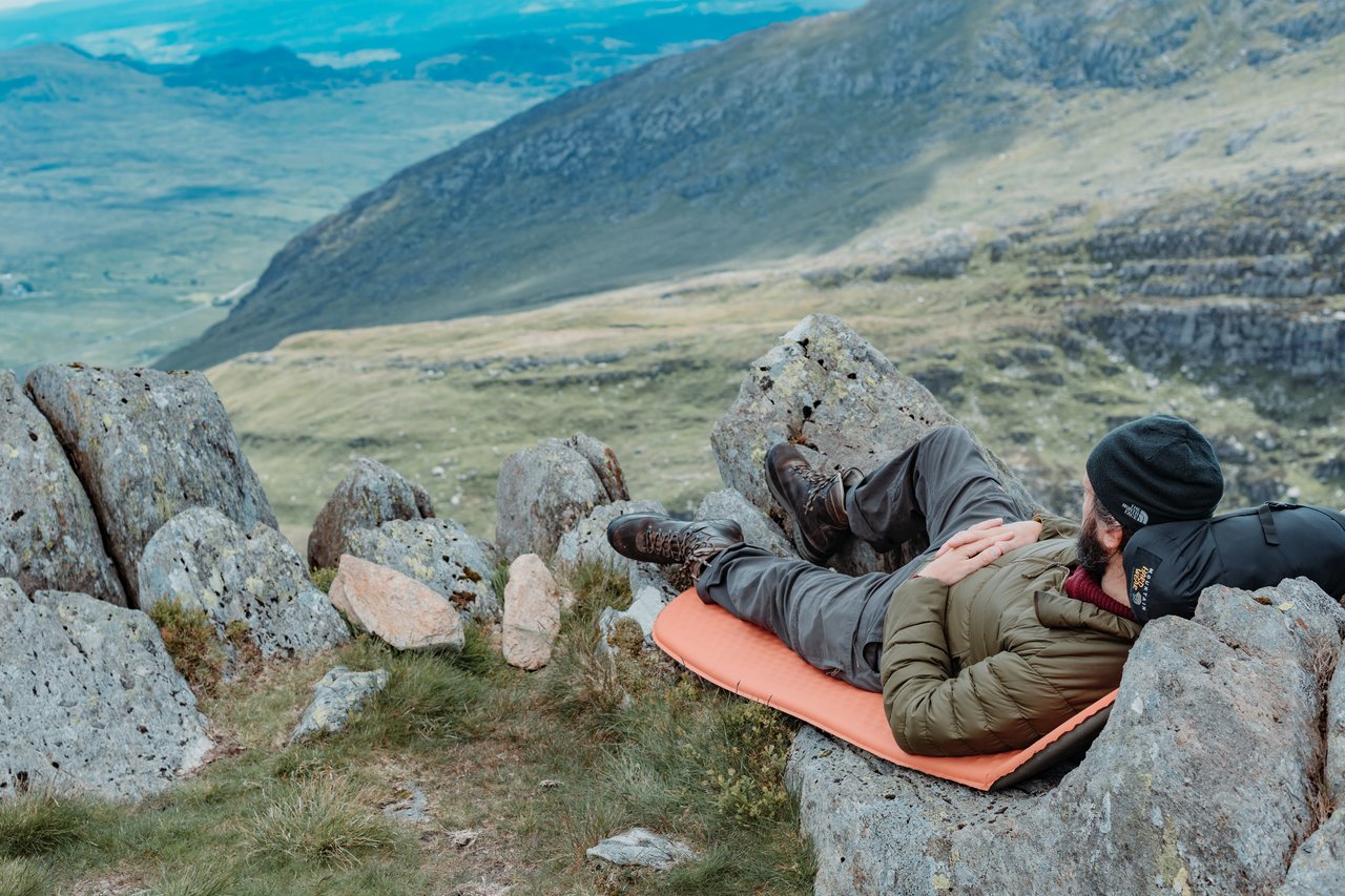 Klaas resting on some rocks looking into the distance after scrambling up Tryfan