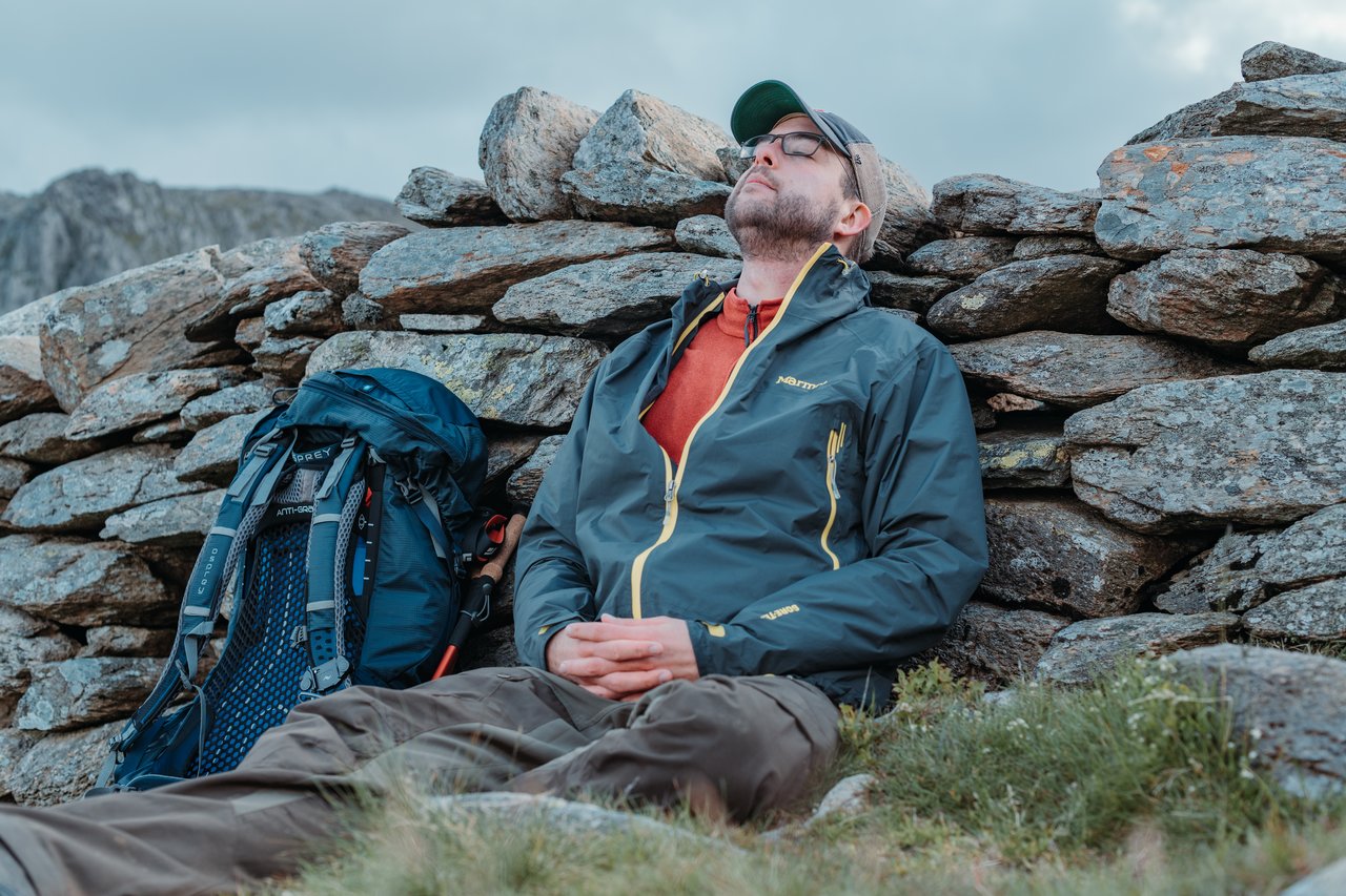 Dries resting against a stone wall after scrambling up Tryfan