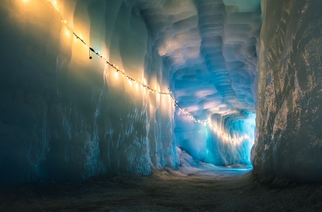 One of the tunnels in the glacier, lid with Christmas lights.