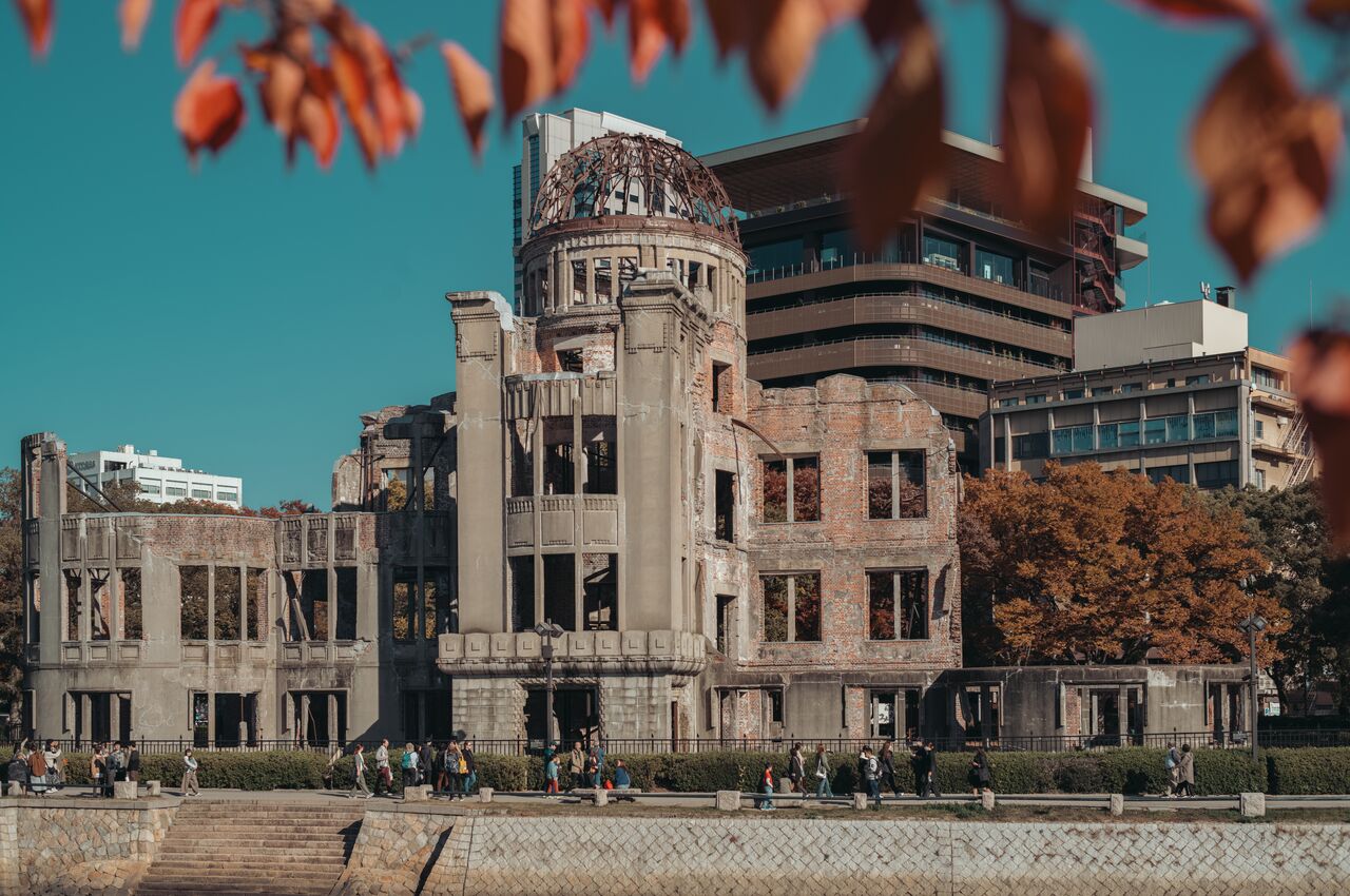 People walk near the Atomic Bomb Dome in Hiroshima, a damaged building that survived the 1945 atomic explosion.