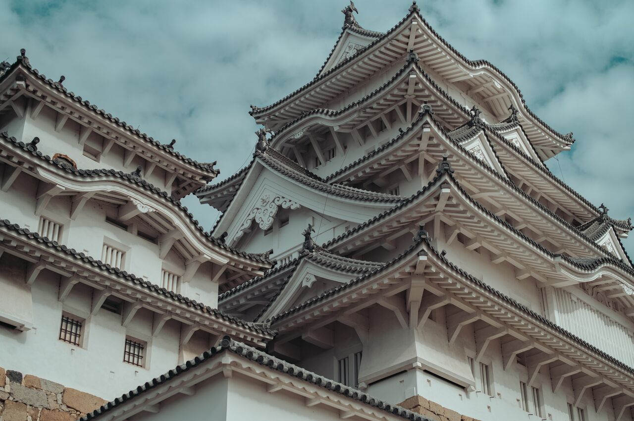 Himeji Castle with its white walls and layered rooftops, showing traditional Japanese architecture and its well-preserved structure through centuries.