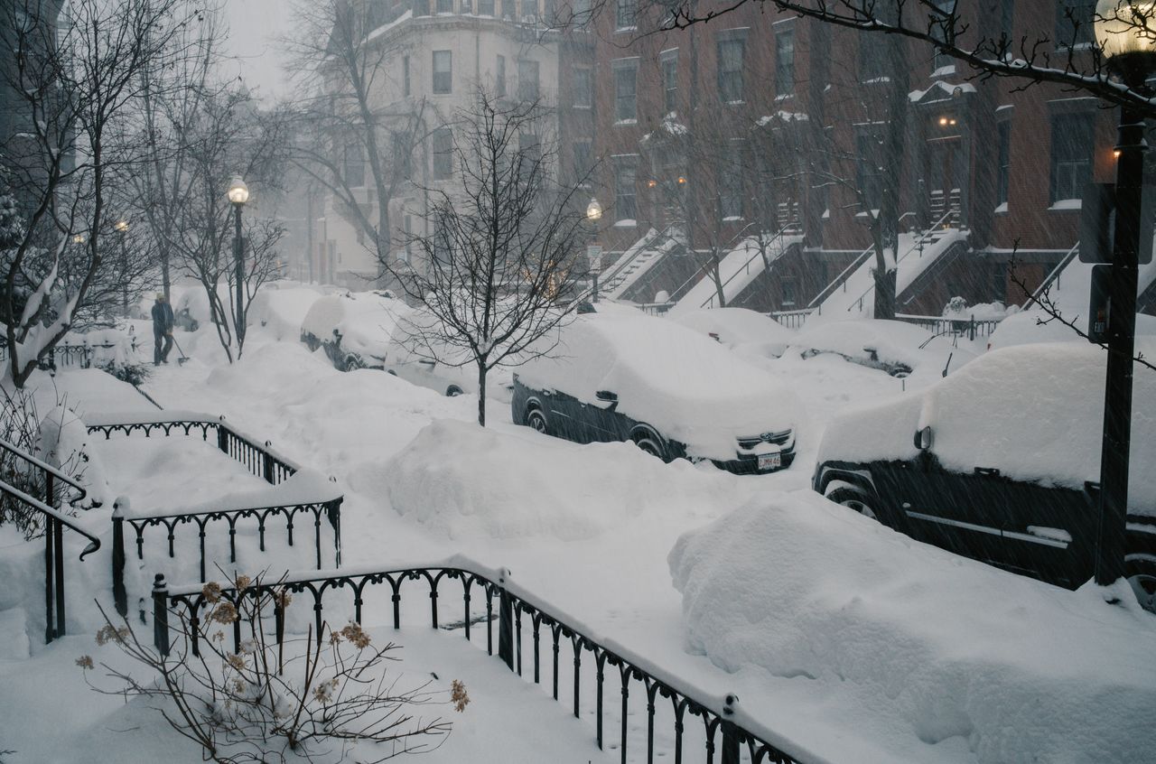 Cars getting buried by heavy Boston snowfall