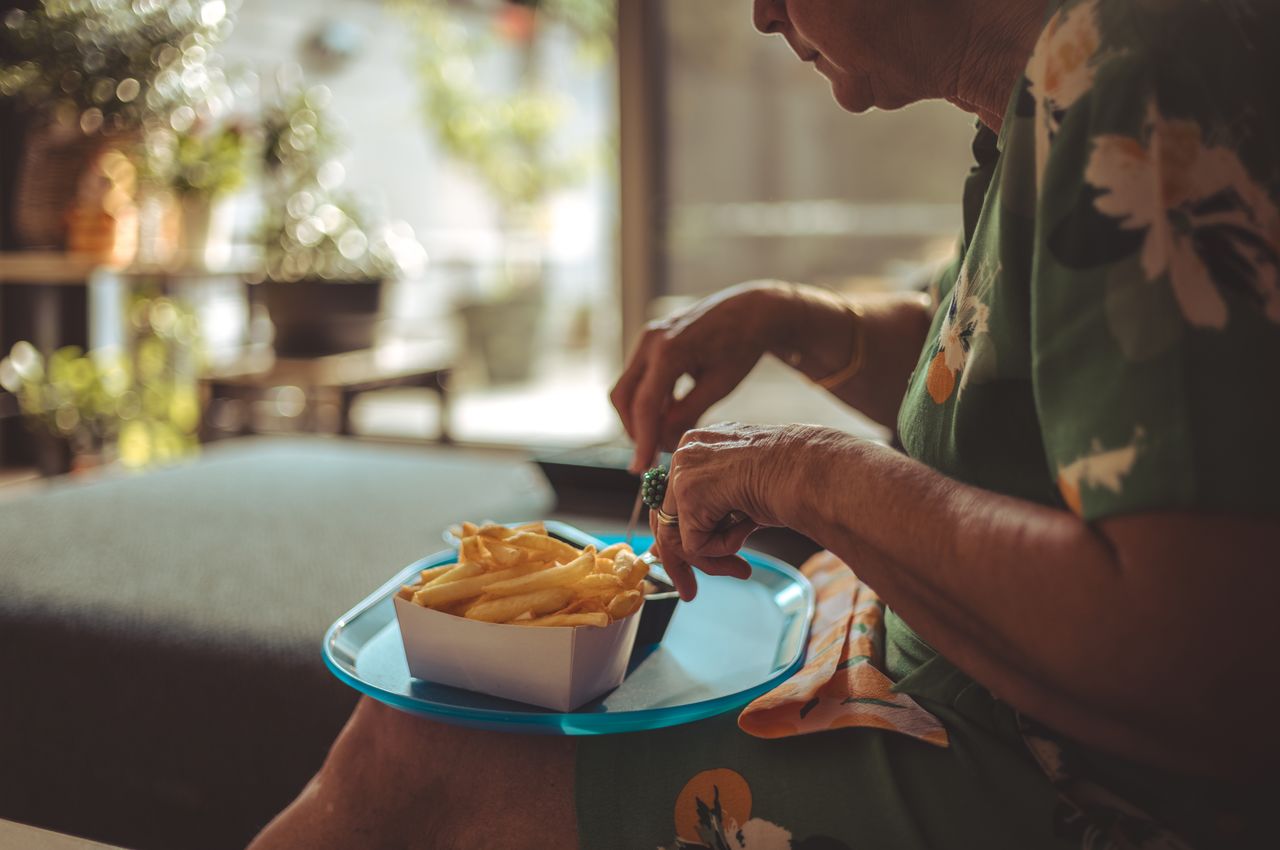My mom eating fries from a nostalgia-filled blue platter.