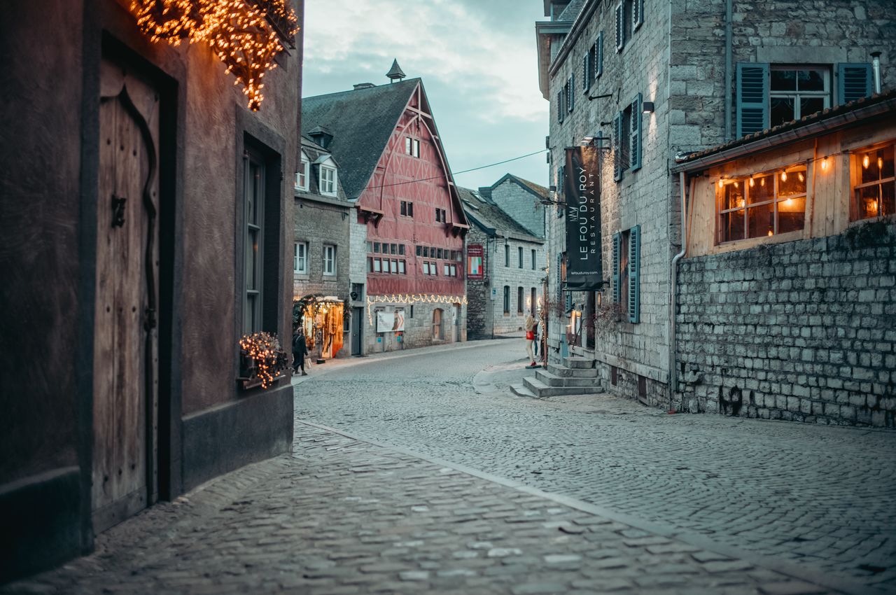 A cobblestone street surrounded by old buildings.