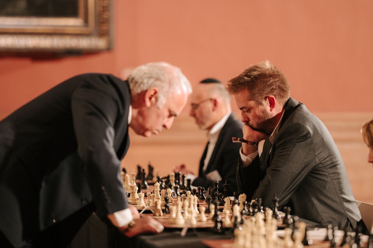 Kasparov studies the board while his opponent concentrates on the next move.