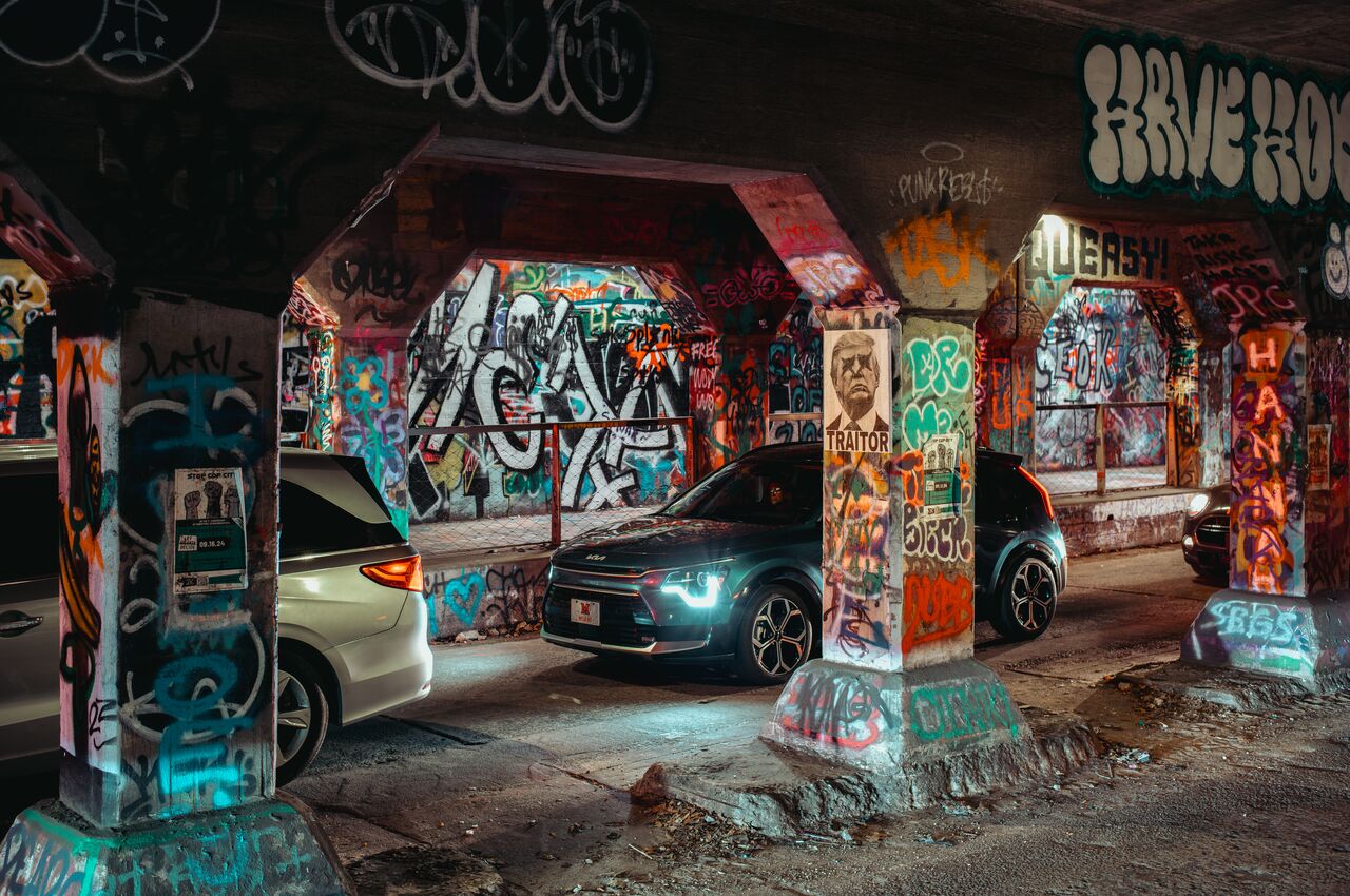 The Krog Street Tunnel is a narrow, dim tunnel in Atlanta, covered in colorful graffiti on every wall and pillar.