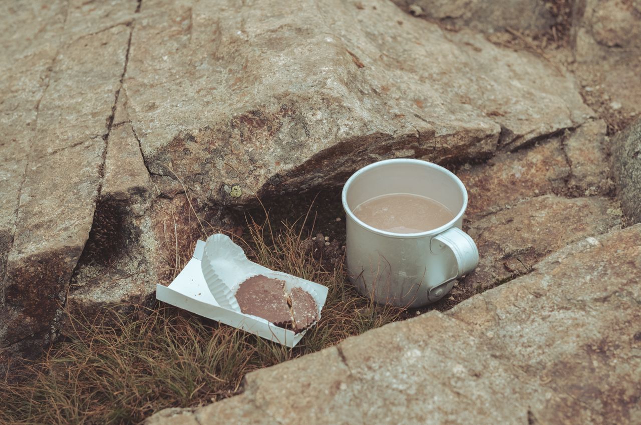 A peanut butter cup next to a cup containing water with an electrolyte tablet.