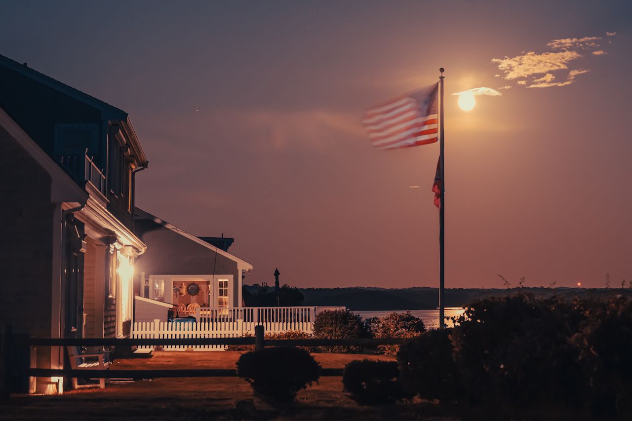 An American flag waving in the light of the moon