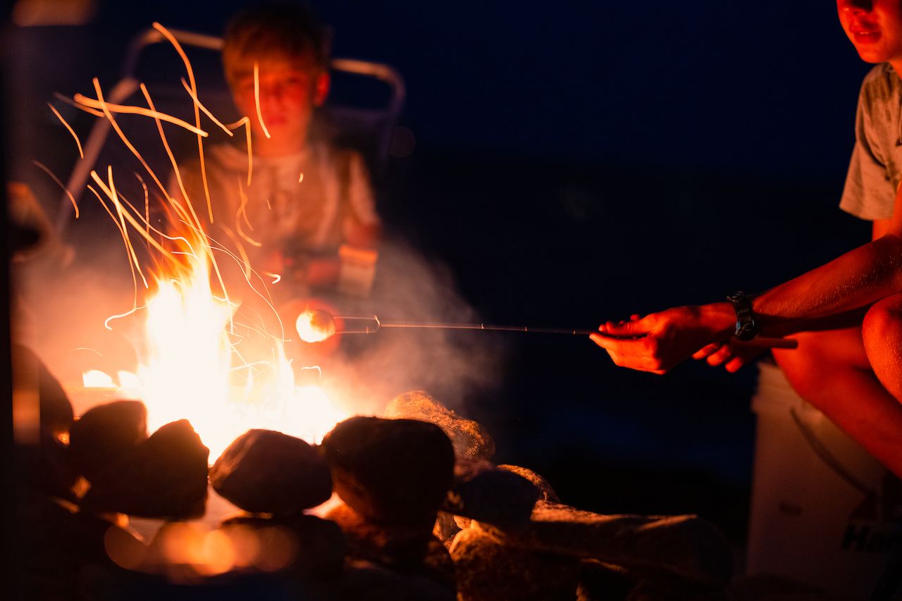 A marshmallow roasting over a campfire.