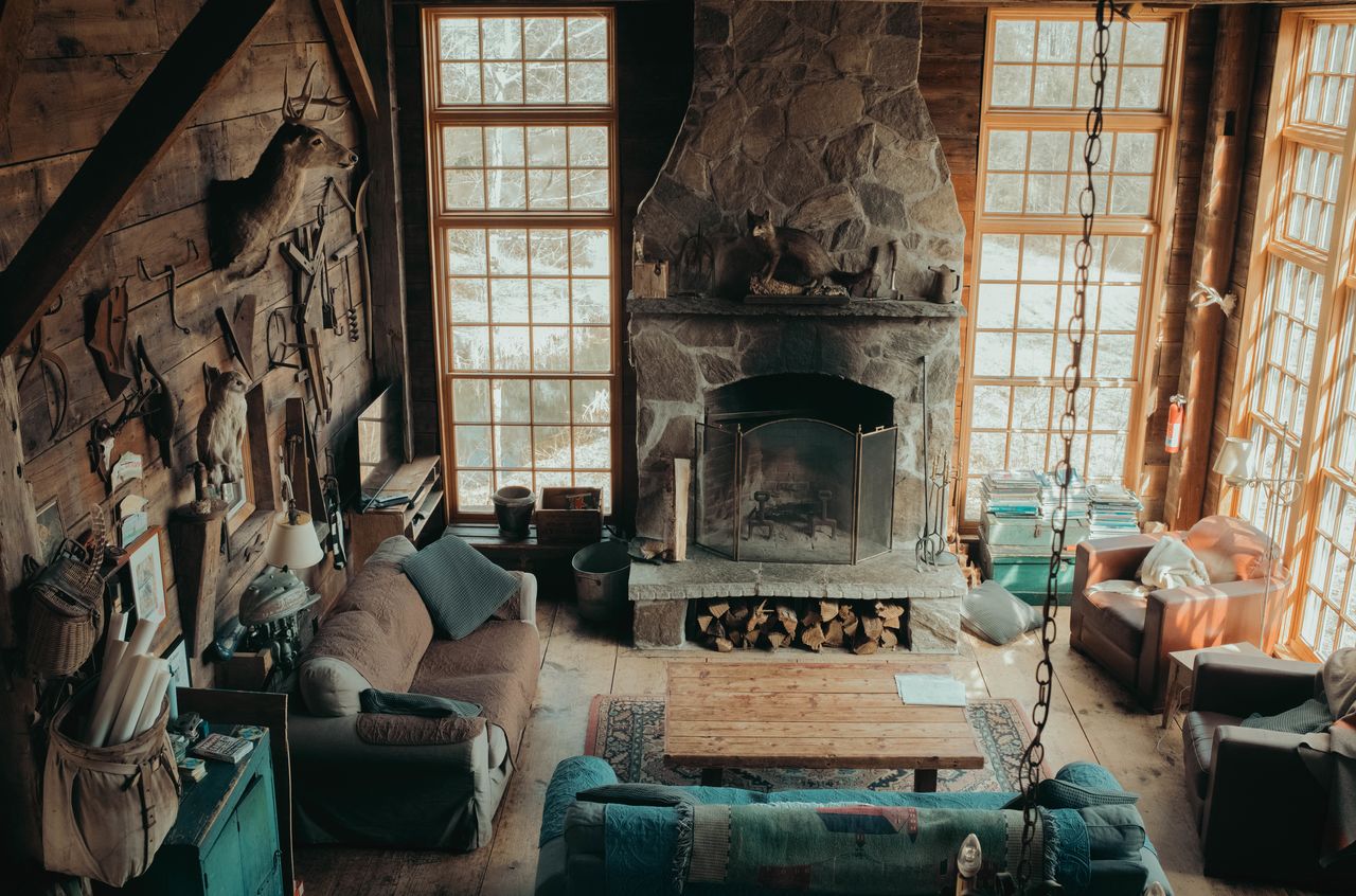 A great room with 20 foot ceiling, tall glass windows and a large fire place
