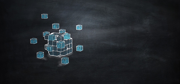 Chalk drawing of a cube made of smaller blue blocks, with some blocks floating apart, on a blackboard background.