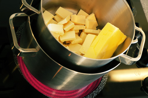 Butter and white chocolate being melted on a stove