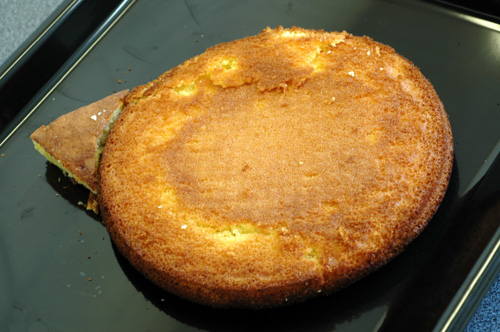 A round cake with a triangular piece on top