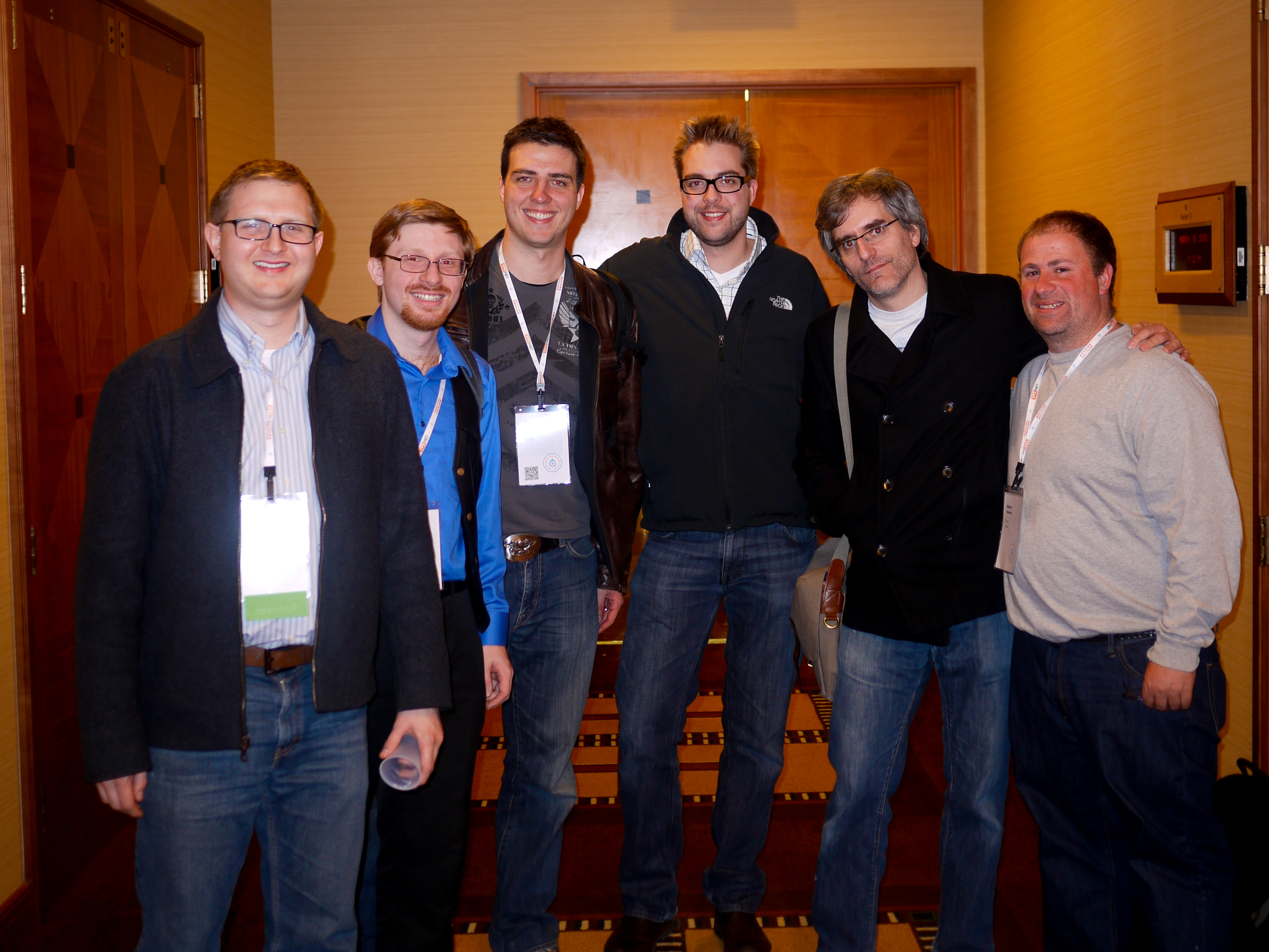 Six people stand together in a hallway, smiling at the camera during a DrupalCon Chicago 2011 configuration management session.