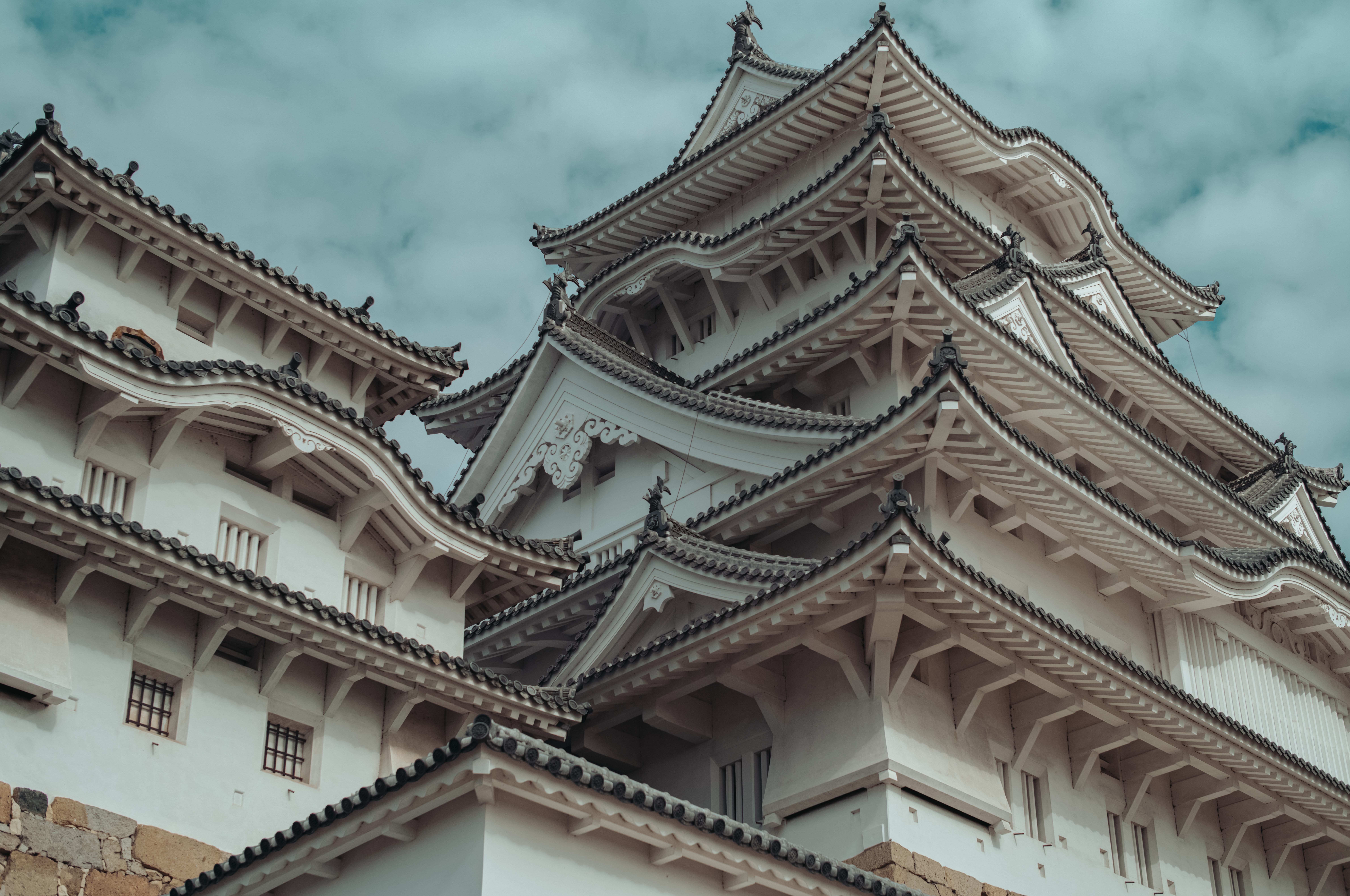 Himeji Castle with its white walls and layered rooftops, showing traditional Japanese architecture and its well-preserved structure through centuries.