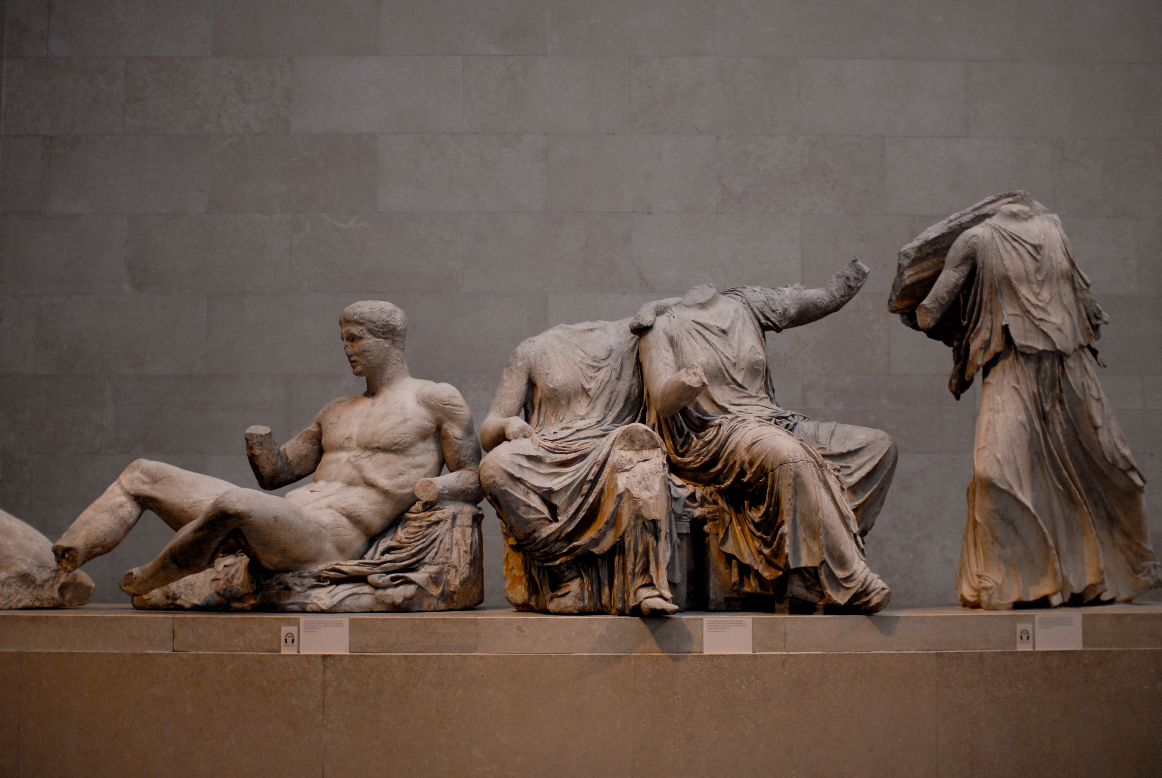 Ancient marble sculptures from the Parthenon's east pediment, depicting reclining and seated figures with missing heads and limbs.